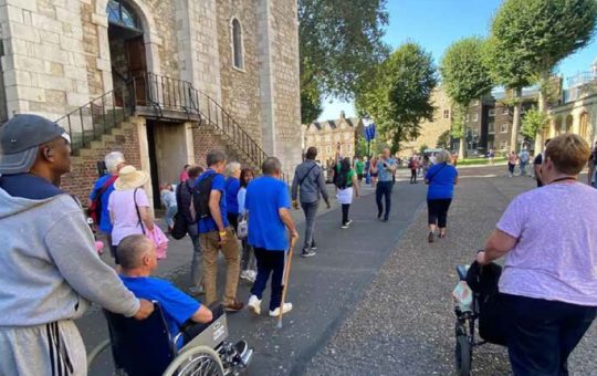 Wheelchair users among a Young Onset Dementia Group at the Tower of London negotiating the varied surfaces with pathways and access routes pre-planned to aid accessibility