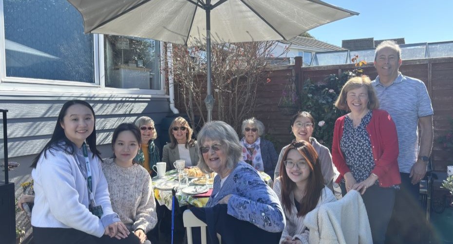 Members of the tech and life pal scheme sitting around a table outside